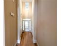 Light-filled foyer with hardwood floors and a glass-paneled front door entrance at 2656 Gadsen Walk, Duluth, GA 30097