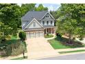 Beautiful two-story home with a two-car garage, lush landscaping, and a long driveway, nestled in a quiet neighborhood at 93 Richmond Way, Villa Rica, GA 30180