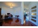 Hallway with views of a dining room and office featuring gleaming hardwood floors and neutral paint at 93 Richmond Way, Villa Rica, GA 30180