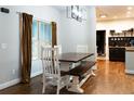 Bright dining area features a dark wood table with white chairs and benches, and a window with natural light at 154 Carmen Ln, Dallas, GA 30157