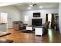 Spacious living room features a stone fireplace, hardwood floors, ceiling fan, and comfortable seating at 154 Carmen Ln, Dallas, GA 30157