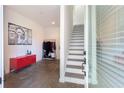 The entryway features stairs, a red cabinet, a coat rack and white walls at 1606 Rock Dam Dr # 11, Atlanta, GA 30317