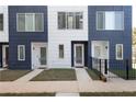The townhouse features a blue and white facade, a small yard and a modern design at 1606 Rock Dam Dr # 11, Atlanta, GA 30317