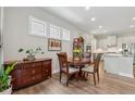 Cozy dining area featuring hardwood floors, elegant light fixture, and a view of the kitchen at 3210 Steinbeck St, Cumming, GA 30041