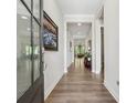 Inviting entryway with hardwood floors, neutral walls, and natural light from the sidelight window at 3210 Steinbeck St, Cumming, GA 30041