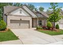 Single-story home featuring a brick facade, well-manicured lawn, and an attached two-car garage at 3210 Steinbeck St, Cumming, GA 30041