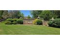 Well-maintained community entrance sign surrounded by lush landscaping and manicured lawns at 7491 Hilltop Way, Atlanta, GA 30349