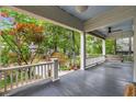 Relaxing covered porch with a swing, ceiling fan, and views of the landscaped front yard at 165 Hale Ne St, Atlanta, GA 30307