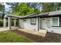 Quaint white brick home featuring a covered carport and fresh landscaping at 2223 Columbia Dr, Decatur, GA 30032