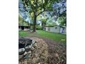 Spacious backyard featuring a fire pit, storage building and a detached structure with room for outdoor activities at 3133 Rebecca St, Covington, GA 30014