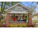Inviting front porch with brick columns and stylish outdoor seating area at 540 Atwood Sw St, Atlanta, GA 30310