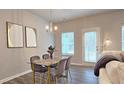 Cozy dining area featuring a glass table, velvet chairs, and natural light at 3401 Endurance Ct # 10, Atlanta, GA 30349