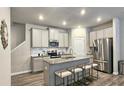 Modern kitchen with stainless steel appliances, granite countertops, and an island with seating at 3401 Endurance Ct # 10, Atlanta, GA 30349