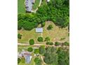 Aerial view of a quaint home surrounded by lush greenery and expansive land at 415 Gray Rd, Carrollton, GA 30116