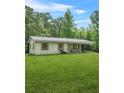 The front yard of a cozy single-story house featuring green shutters and well-manicured lawn at 415 Gray Rd, Carrollton, GA 30116