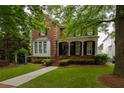 Charming two-story brick home with a welcoming front porch and beautifully landscaped front yard at 2174 Basque Se Dr, Smyrna, GA 30080