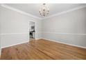 Dining area with hardwood floors, chandelier, and view to the kitchen at 4914 Brown Leaf Dr, Powder Springs, GA 30127