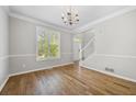 Bright living room features hardwood floors, large window, and white trim at 4914 Brown Leaf Dr, Powder Springs, GA 30127
