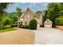 Brick home features an additional garage and driveway at 5045 Huntwood Way, Roswell, GA 30075