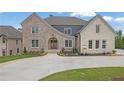 Beautiful home with a brick and stone exterior, complemented by professional landscaping at 5753 Brendlynn Dr, Suwanee, GA 30024