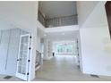 Open foyer with clerestory and light wood floors leading to spacious interior at 5753 Brendlynn Dr, Suwanee, GA 30024