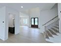 Bright foyer featuring wood floors, soaring ceilings, and decorative staircase at 5753 Brendlynn Dr, Suwanee, GA 30024