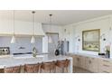 Beautiful kitchen with waterfall edge island seating and neutral decor at 5753 Brendlynn Dr, Suwanee, GA 30024