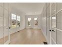 Bright and airy room featuring white walls, hardwood floors, and large windows at 5753 Brendlynn Dr, Suwanee, GA 30024