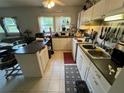 A well-lit kitchen featuring white cabinets, tile flooring, and an island at 2539 Dogwood Hills Ct, Austell, GA 30106