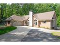 Charming brick home featuring an attached garage and well-maintained landscaping at 320 Williamsburg Cir, Mcdonough, GA 30253