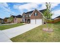 Beautiful brick house featuring a well-maintained lawn and concrete driveway at 3236 Papyrus Palm Rd, Loganville, GA 30052