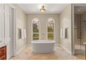 Luxurious bathroom featuring a standalone tub, elegant fixtures, and a glass-enclosed shower at 1477 Highway 85 Connector, Brooks, GA 30205