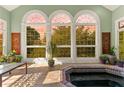 Bright sunroom with large arched windows, tiled floors, and a relaxing jacuzzi tub at 1477 Highway 85 Connector, Brooks, GA 30205
