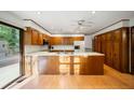 An expansive kitchen with wood cabinets, an island, and sliding door access to the deck, creating an airy space at 170 Mark Nw Trl, Sandy Springs, GA 30328