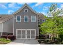 Two-story gray home with a two-car garage, landscaped yard, and a welcoming front entrance at 1914 Coal Pl, Atlanta, GA 30318