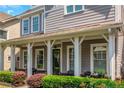 Inviting front porch with stylish columns, seating, and a well-maintained garden at 1914 Coal Pl, Atlanta, GA 30318