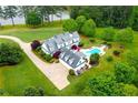 Stunning aerial view of a home with a pool and a pond, showcasing the home's private and serene setting at 1415 N Flat Rock Rd, Douglasville, GA 30134