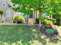 Attractive home boasting a manicured lawn, vibrant shrubbery, and a stone-lined garden area with blooming flowers at 1615 Mount Mckinley Dr, Grayson, GA 30017