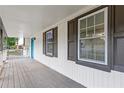 Home's covered porch, showcasing the inviting space with window views and classic architectural details at 353 Old Rosser Rd, Stone Mountain, GA 30087