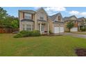 Attractive two-story home with a manicured lawn and a convenient two-car garage at 5130 Hopewell Manor Dr, Cumming, GA 30028