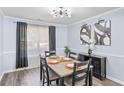 Charming dining area featuring modern light fixture, seating for six, and decorative accents at 5885 Raventree Ct, South Fulton, GA 30349
