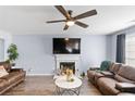 Comfortable living room with a fireplace, hardwood floors and great natural light at 5885 Raventree Ct, South Fulton, GA 30349