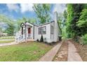 An angled view showcasing the side yard and updated exterior of the home at 942 Lawton Sw St, Atlanta, GA 30310