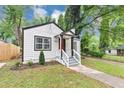 Inviting front exterior with a classic design, fresh landscaping, and a pop of color with the red door at 942 Lawton Sw St, Atlanta, GA 30310