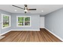 Spacious living room with new floors, large windows, and a modern ceiling fan at 942 Lawton Sw St, Atlanta, GA 30310
