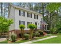 Beautiful two-story home with a brick foundation, black shutters, and a manicured lawn surrounded by trees at 1275 Mayfield Rd, Alpharetta, GA 30009
