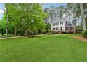 Spacious front yard showcasing a two-story home with brick accents, black shutters, and a well-kept lawn at 1275 Mayfield Rd, Milton, GA 30009