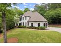 Elegant home with lush landscaping and a well-maintained lawn at 725 Danbridge Way, Roswell, GA 30076