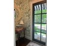 Elegant entryway featuring stylish wallpaper, mirror, and a view to the exterior at 820 Wilson Nw Rd, Atlanta, GA 30318