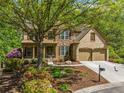 Charming two-story home boasts a stone and brick facade, two car garage and a beautifully landscaped front yard at 121 Brendylynn Trce, Woodstock, GA 30188